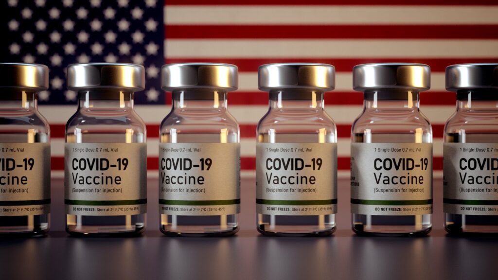 Corona Vaccines / Covid Vaccine Ampules in front of American Flag / Vaccination in USA